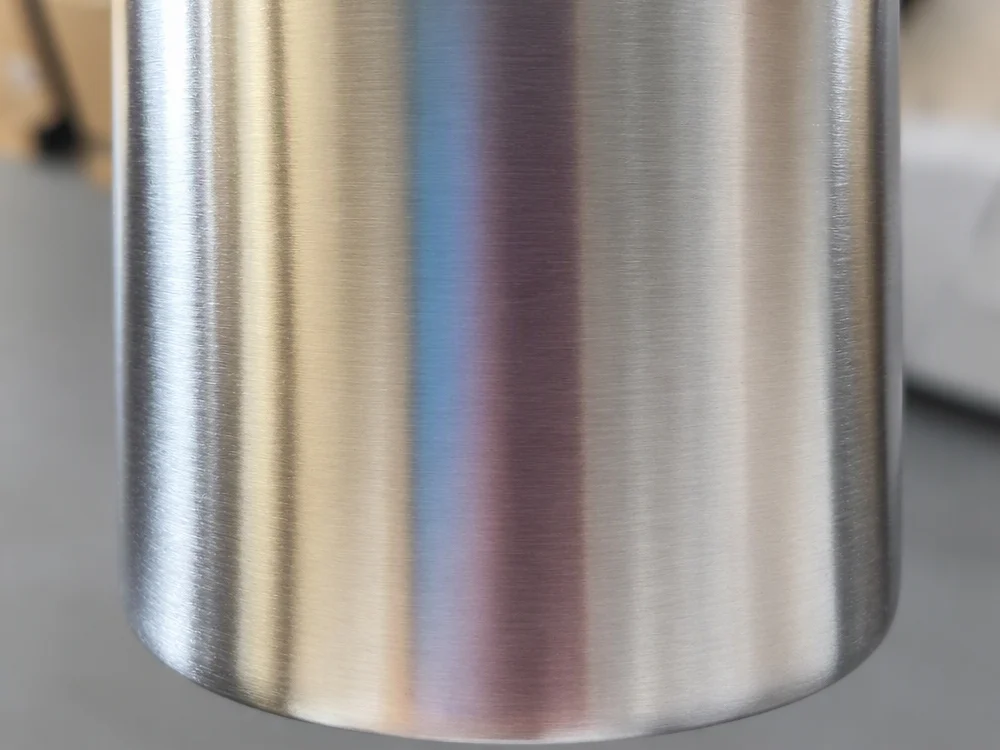 Close-up of a brushed and polished stainless steel surface