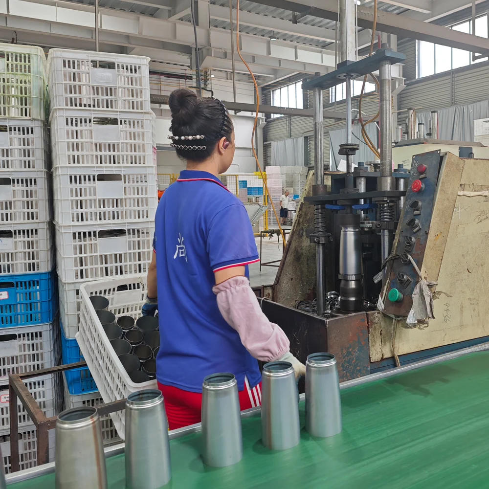 Worker operating a machine on the drinkware production line